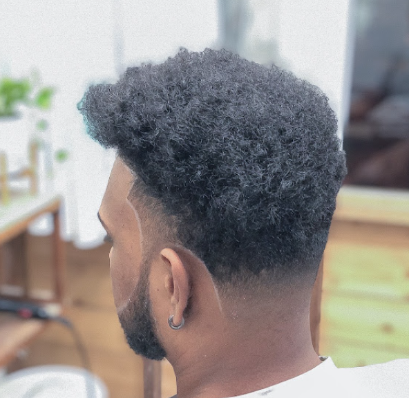 Natural afro-textured hair with a tapered fade on the sides